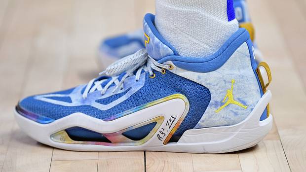 Side view of Jayson Tatum's blue and gold Jordan Brand sneakers.