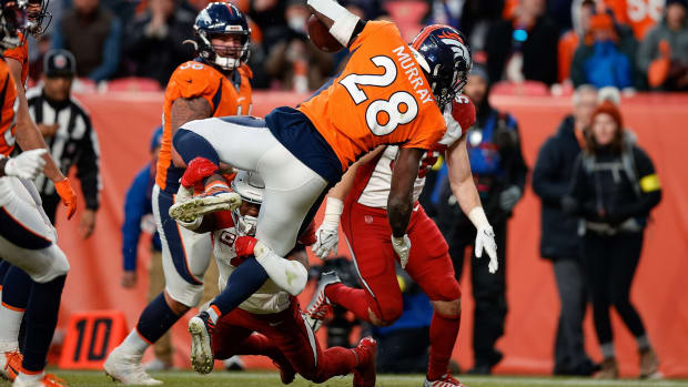 Denver Broncos running back Latavius Murray (28) dives for a touchdown against Arizona Cardinals safety Budda Baker (3) in the fourth quarter at Empower Field at Mile High.