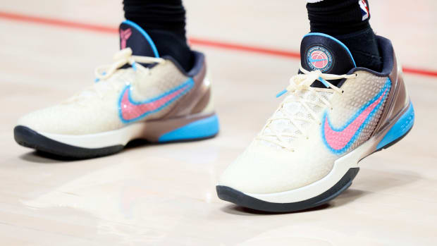 View of white, pink, and blue Nike Kobe shoes.