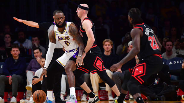 Chicago Bulls guard Alex Caruso defends Los Angeles Lakers forward LeBron James.