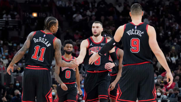 Chicago Bulls guard Zach LaVine celebrates a three point basket with teammates DeMar DeRozan and Nikola Vucevic