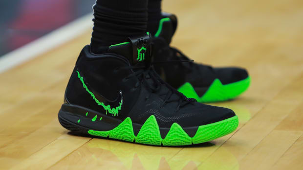 Black and green Nike Kyrie 4 shoes.