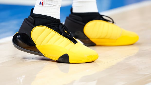 View of yellow and black adidas shoes.
