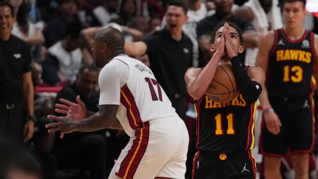 Apr 19, 2022; Miami, Florida, USA; Atlanta Hawks guard Trae Young (11) reacts after being fouled by Miami Heat forward P.J. Tucker (17) during the second half in game two of the first round for the 2022 NBA playoffs at FTX Arena.