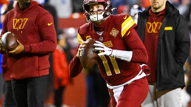 Washington Commanders quarterback Carson Wentz (11) warms up before the game against the New York Giants at FedExField.