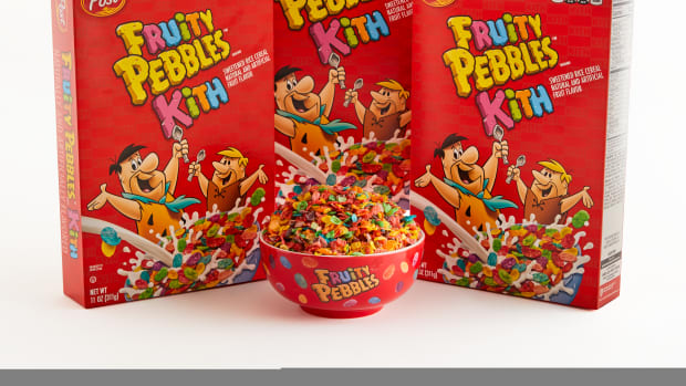 Fruity Pebbles cereal boxes next to a cereal bowl.