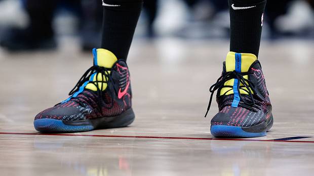 View of Karl-Anthony Towns' black and yellow Nike shoes.