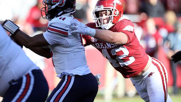 Arkansas Razorbacks linebacker Drew Sanders (42) tackles Liberty Flames quarterback Johnathan Bennett (11) in the second quarter at Donald W. Reynolds Razorback Stadium.