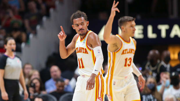 Atlanta Hawks guard Trae Young (11) celebrates after a three pointer with guard Bogdan Bogdanovic (13) against the Miami Heat in the first half at State Farm Arena.