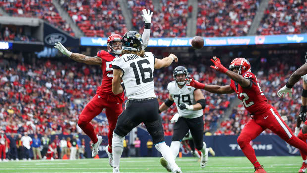 Jaguars quarterback Trevor Lawrence (16) attempts a pass as Houston Texans linebacker Blake Cashman (53) during the third quarter at NRG Stadium.