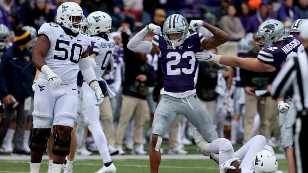 Nov 13, 2021; Manhattan, Kansas, USA; Kansas State Wildcats defensive back Julius Brents (23) celebrates the tackle of West Virginia Mountaineers running back Leddie Brown (4) during the third quarter at Bill Snyder Family Football Stadium. Mandatory Credit: Scott Sewell-USA TODAY Sports