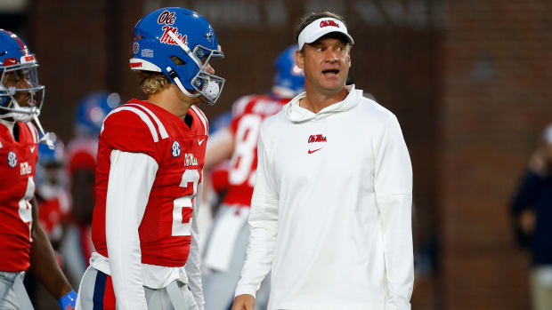Oct 28, 2023; Oxford, Mississippi, USA; Mississippi Rebels head coach Lane Kiffin (right) talks with quarterback Jaxson Dart (2) during warm ups prior to the game against the Vanderbilt Commodores at Vaught-Hemingway Stadium. Mandatory Credit: Petre Thomas-USA TODAY Sports