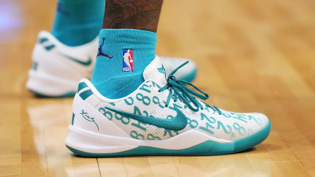 Charlotte Hornets guard Terry Rozier's white and teal Nike Kobe sneakers.