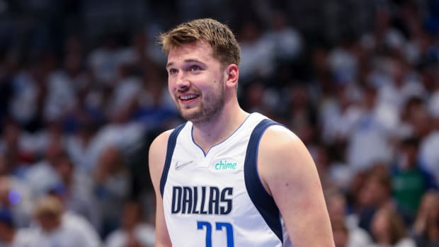 Luka Doncic smiles during a game.