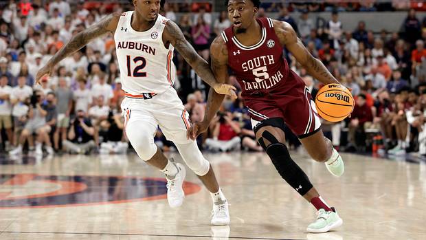 South Carolina guard Jermaine Couisnard (5) dribbles around Auburn guard Zep Jasper (12) as he goes to the basket during the first half of an NCAA college basketball game Saturday, March 5, 2022, in Auburn, Ala. (AP Photo/Butch Dill)
