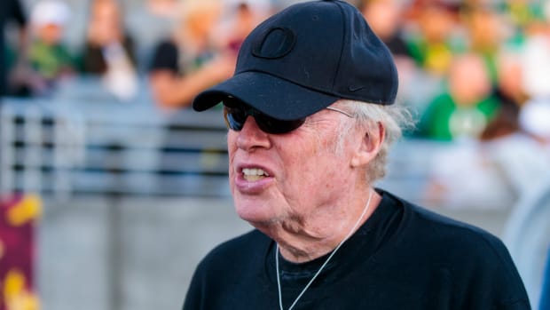 Phil Knight on the sidelines at a football game.