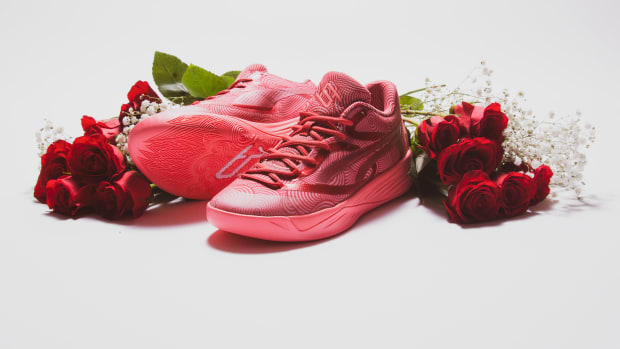 Breanna Stewart's pink and red PUMA sneakers next to roses.