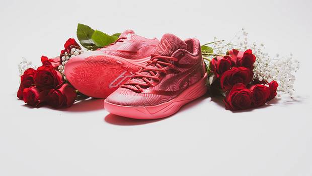 Breanna Stewart's pink and red PUMA sneakers next to roses.