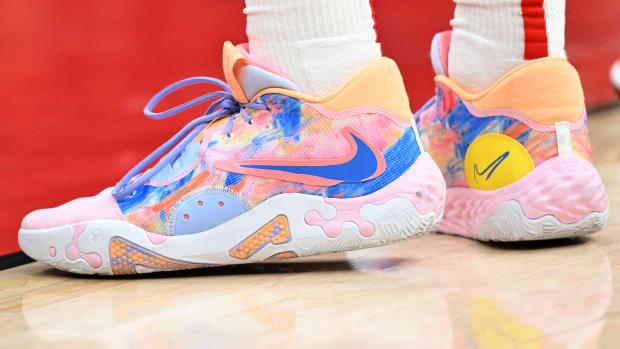 View of pink and blue Nike PG shoes.