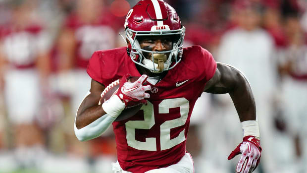 Alabama Crimson Tide running back Justice Haynes on a rushing attempt during a college football game.