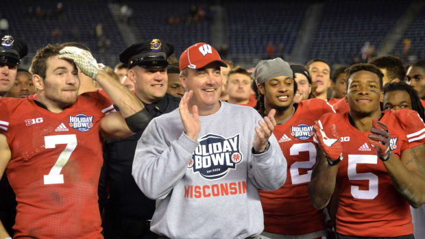 Paul Chryst smiling with players after winning the Holiday Bowl.