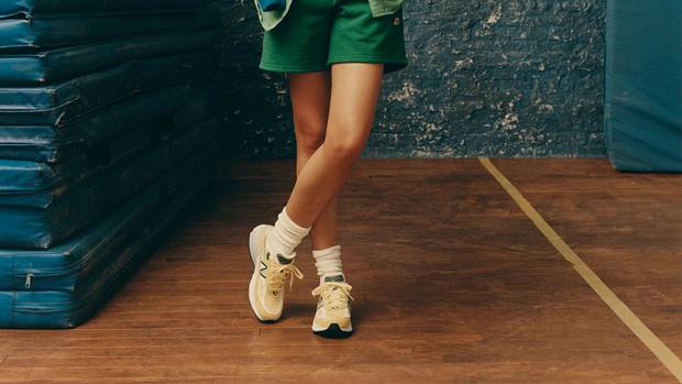 Female model poses in New Balance clothing.
