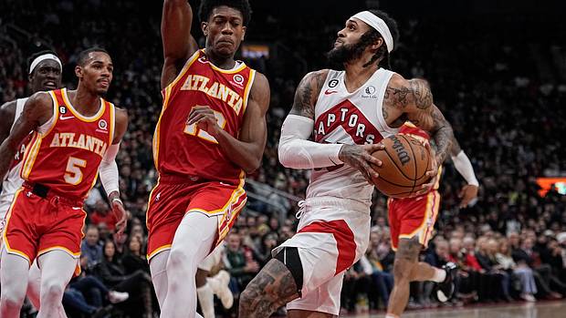 Raptors guard Gary Trent Jr. dribbles to the rim against Hawks forward De'Andre Hunter.