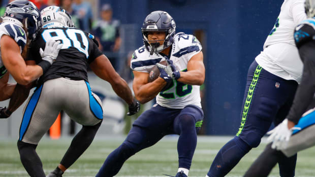 Seattle Seahawks running back Zach Charbonnet (26) rushes against the Carolina Panthers during the fourth quarter at Lumen Field.