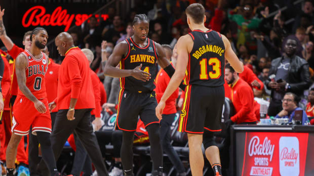 Hawks forward AJ Griffin and Hawks guard Bogdan Bogdanovic react after a play.