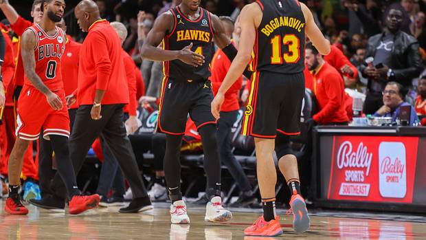 Hawks forward AJ Griffin and Hawks guard Bogdan Bogdanovic react after a play.