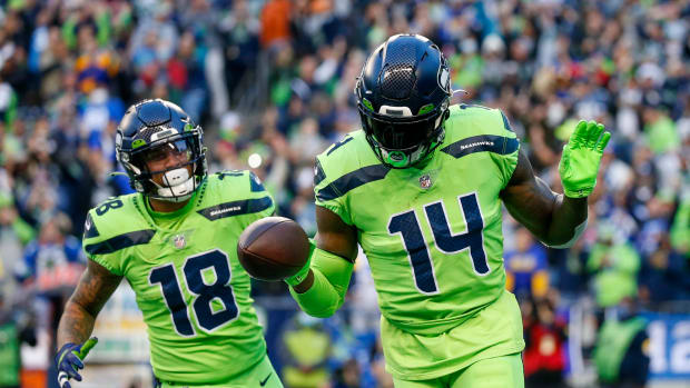 Seattle Seahawks wide receiver DK Metcalf (14) celebrates with wide receiver Freddie Swain (14) after catching a touchdown pass against the Los Angeles Rams during the second quarter at Lumen Field.