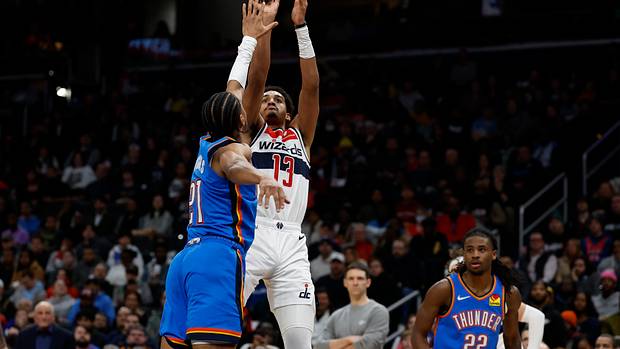 Washington Wizards guard Jordan Poole (13) shoots the ball over Oklahoma City Thunder guard Aaron Wiggins (21) in the third quarter at Capital One Arena.