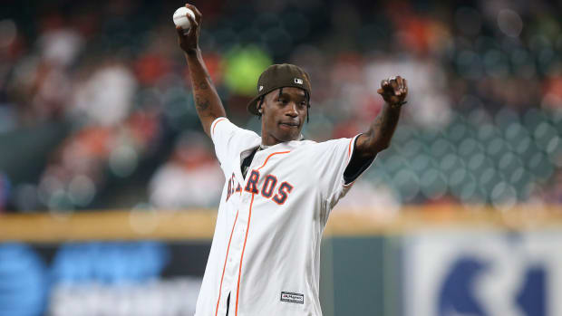 Travis Scott throws out the ceremonial first pitch before a game.