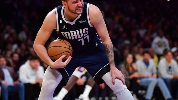 Dallas Mavericks superstar Luka Doncic grimaces after pulling down a rebound during the 2022-23 NBA season.