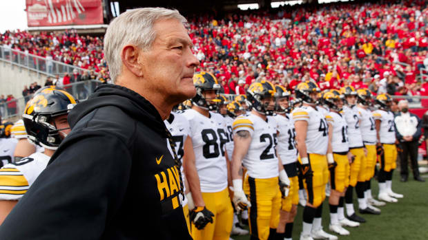 Iowa head coach Kirk Ferentz standing with his team before running out at Camp Randall Stadium in 2021.