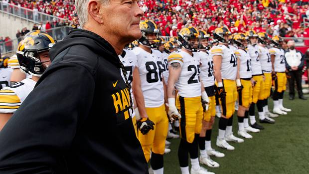 Iowa head coach Kirk Ferentz standing with his team before running out at Camp Randall Stadium in 2021.