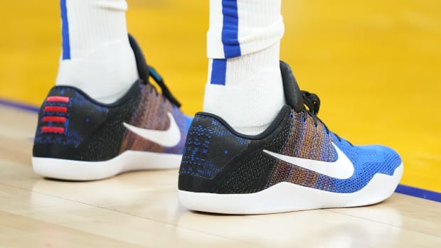 View of black, blue, and white Nike Kobe shoes.
