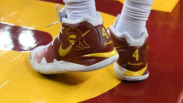View of cardinal and gold Nike Kyrie shoes.