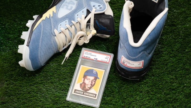 View of blue cleats and Jackie Robinson baseball card.