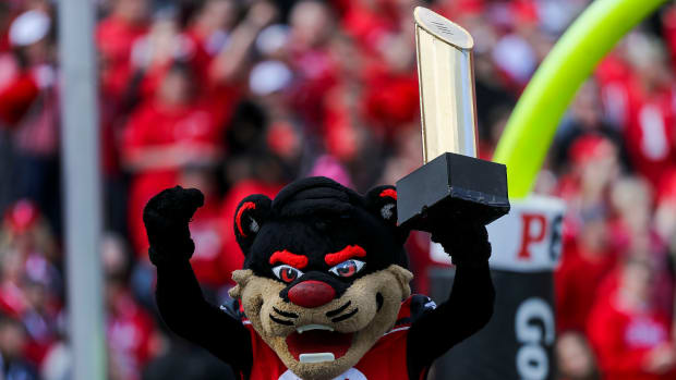 Oct 16, 2021; Cincinnati, Ohio, USA; The Cincinnati Bearcats mascot holds up the College Football Playoff National Championship trophy after a touchdown against the UCF Knights in the first half at Nippert Stadium. Mandatory Credit: Katie Stratman-USA TODAY Sports