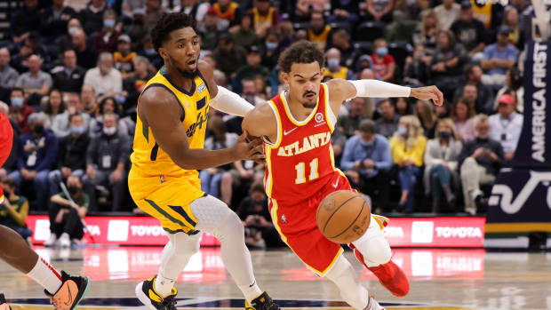Atlanta Hawks guard Trae Young (11) tries to dribble away from Utah Jazz guard Donovan Mitchell (45) during the first quarter at Vivint Arena.