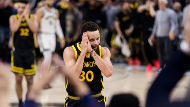 Golden State Warriors guard Stephen Curry reacts after scoring against the Boston Celtics.