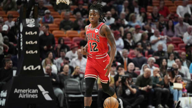 Chicago Bulls guard Ayo Dosunmu brings the ball up the court against the Miami Heat during season opener