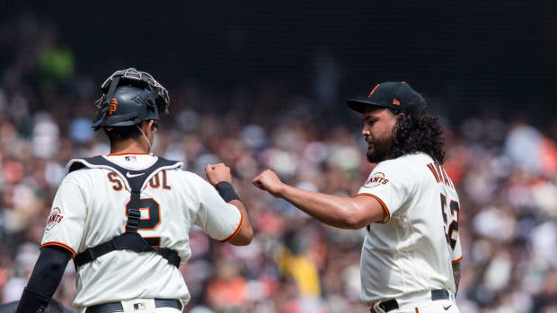 SF Giants starting pitcher Sean Manaea and catcher Blake Sabol fist-bump during a game against the Royals. (2023)