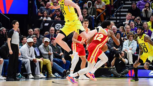 Hawks forward De'Andre Hunter dribbles past Jazz forward Kelly Olynyk.