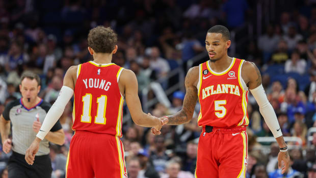 Hawks guards Dejounte Murray and Trae Young shake hands.