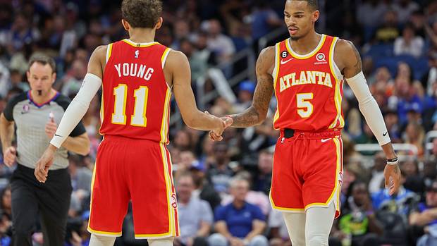 Hawks guards Dejounte Murray and Trae Young shake hands.