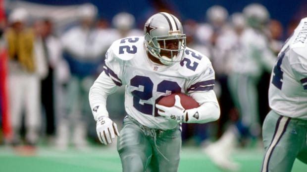Dallas Cowboys running back Emmitt Smith carries the football.