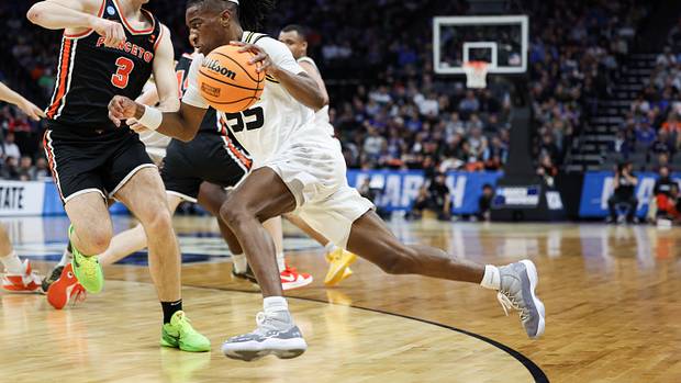 Missouri Tigers guard Sean East II dribbles past Princeton Tigers guard Ryan Langborg.