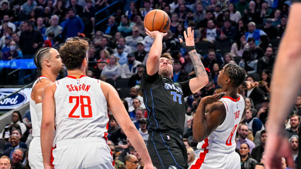 Dallas Mavericks star Luka Doncic draws the defensive attention of three Houston Rockets defenders.